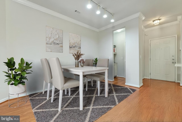 9480 Virginia Center Blvd Unit 327, Vienna, VA 22181 - dining room with wood finished floors, rail lighting, and crown molding