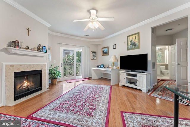 9480 Virginia Center Blvd Unit 327, Vienna, VA 22181 - living area featuring light wood finished floors, ceiling fan, crown molding, and a fireplace with flush hearth
