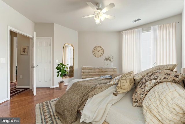 9480 Virginia Center Blvd Unit 327, Vienna, VA 22181 - bedroom with wood finished floors, a ceiling fan, and multiple windows
