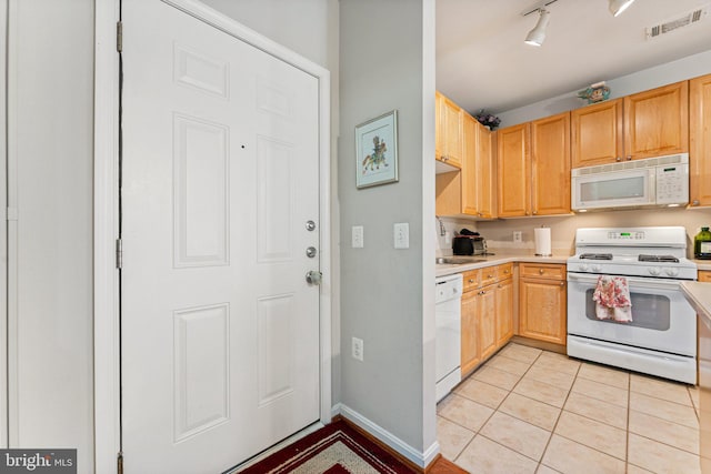 9480 Virginia Center Blvd Unit 327, Vienna, VA 22181 - kitchen with white appliances, light countertops, light brown cabinetry, and light tile patterned floors
