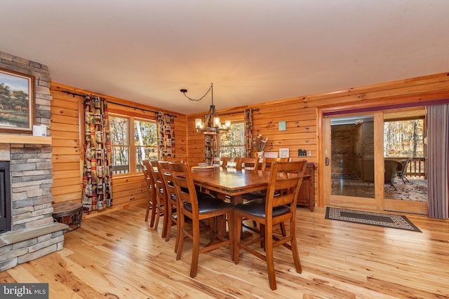 45 Marble Way, Mc Henry, MD 21541 - dining area featuring light wood finished floors, a chandelier, a stone fireplace, and wood walls