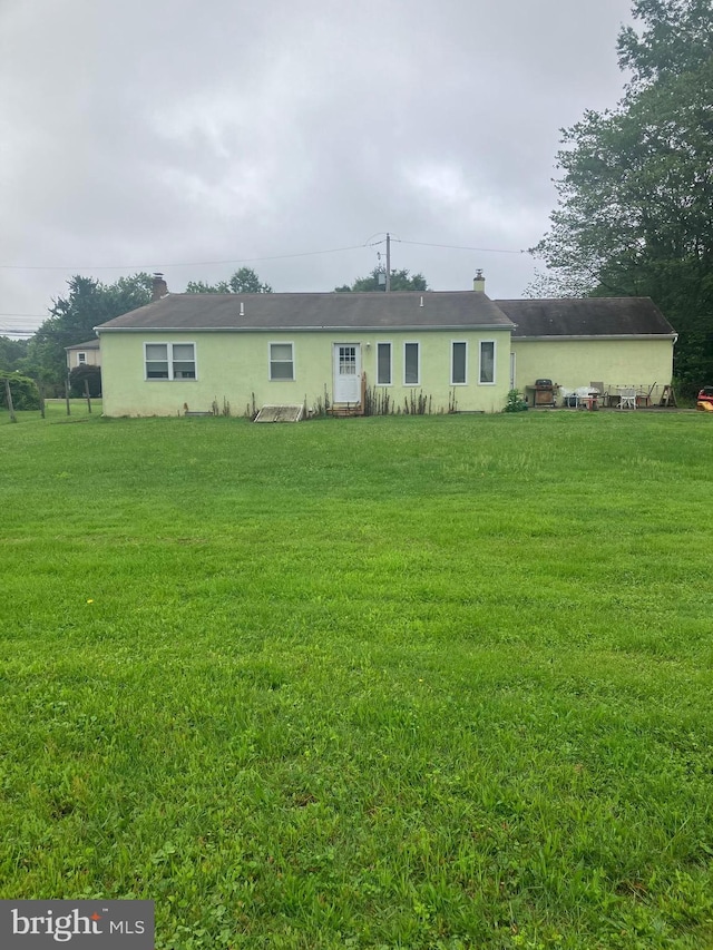 1336 Moyer Rd, Hatfield, PA 19440 - rear view of property featuring a lawn, a chimney, and stucco siding