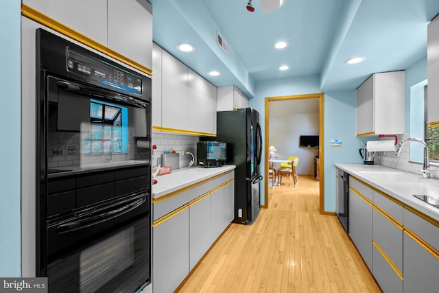 114 Lloyd Guessford Rd, Townsend, DE 19734 - kitchen with black appliances, recessed lighting, light wood finished floors, decorative backsplash, and light countertops