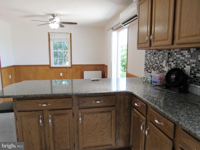 3590 Choptank Rd, Preston, MD 21655 - kitchen with a wall mounted AC, a peninsula, plenty of natural light, wainscoting, and a ceiling fan