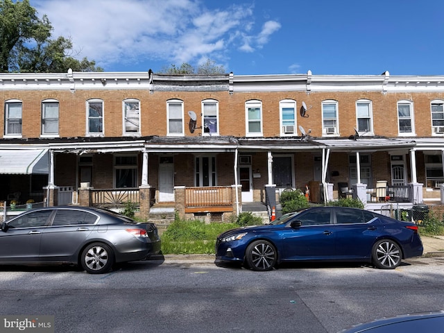 1031 N Ashburton St, Baltimore, MD 21216 - view of front facade featuring brick siding and covered porch
