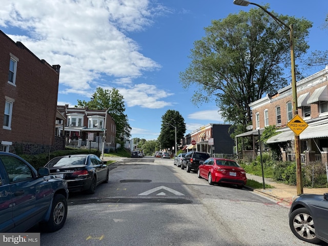 1031 N Ashburton St, Baltimore, MD 21216 - view of asphalt road with street lighting, a residential view, sidewalks, traffic signs, and curbs