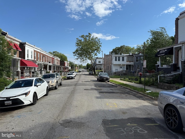 1031 N Ashburton St, Baltimore, MD 21216 - view of asphalt road featuring a residential view, sidewalks, and curbs