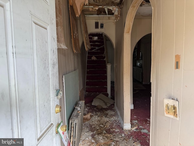 1031 N Ashburton St, Baltimore, MD 21216 - hallway featuring arched walkways, radiator, and stairs
