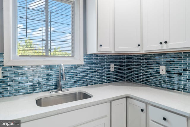 1955 N Collington Ave, Baltimore, MD 21213 - kitchen featuring white cabinetry and decorative backsplash