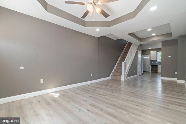 1955 N Collington Ave, Baltimore, MD 21213 - spare room with a tray ceiling, stairway, ceiling fan, light wood-type flooring, and recessed lighting