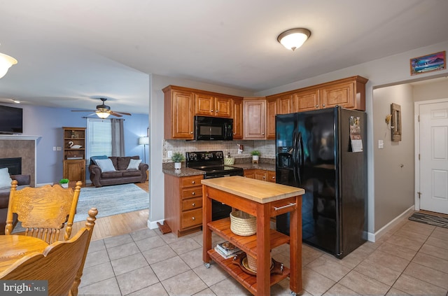 1905 Reading Blvd, Reading, PA 19609 - kitchen featuring black appliances, light tile patterned floors, tasteful backsplash, and open floor plan