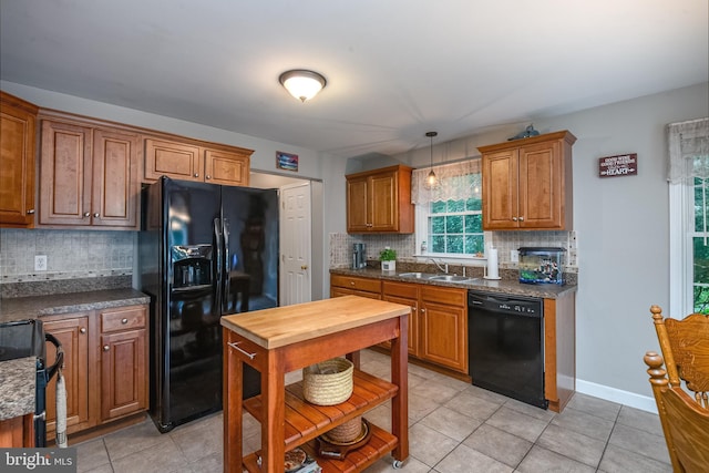 1905 Reading Blvd, Reading, PA 19609 - kitchen with black appliances, light tile patterned floors, decorative backsplash, and hanging light fixtures