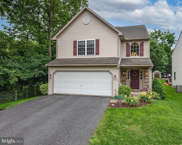 1905 Reading Blvd, Reading, PA 19609 - traditional-style house featuring an attached garage, asphalt driveway, a front yard, roof with shingles, and stone siding