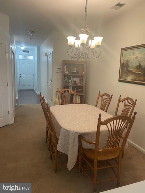 103 Raphael Ct, Williamstown, NJ 08094 - carpeted dining room with a chandelier and baseboards