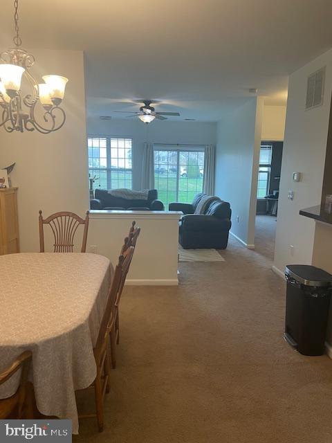 103 Raphael Ct, Williamstown, NJ 08094 - dining space with a chandelier, carpet, and ceiling fan