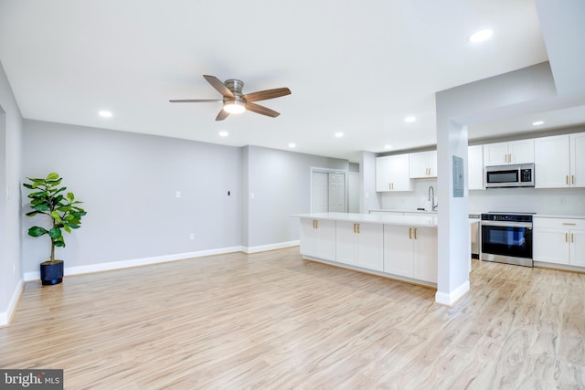 9704 Kingsbridge Dr Unit 203, Fairfax, VA 22031 - kitchen featuring stainless steel appliances, light wood-style floors, light countertops, ceiling fan, and recessed lighting