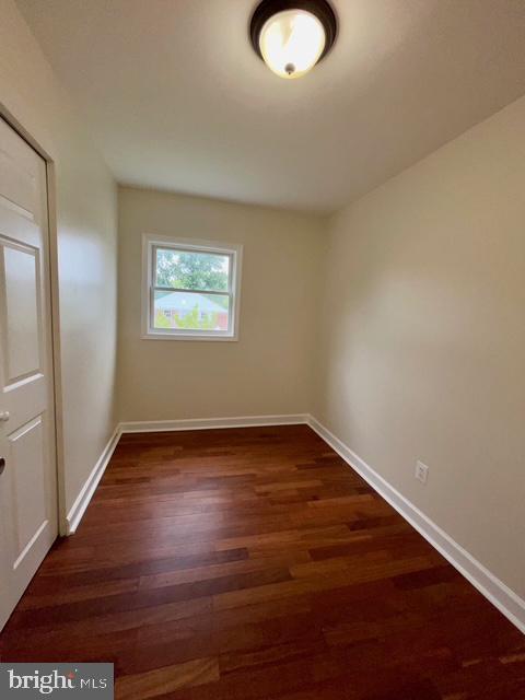 2301 Wyngate Rd, Suitland, MD 20746 - unfurnished room with dark wood-type flooring and baseboards