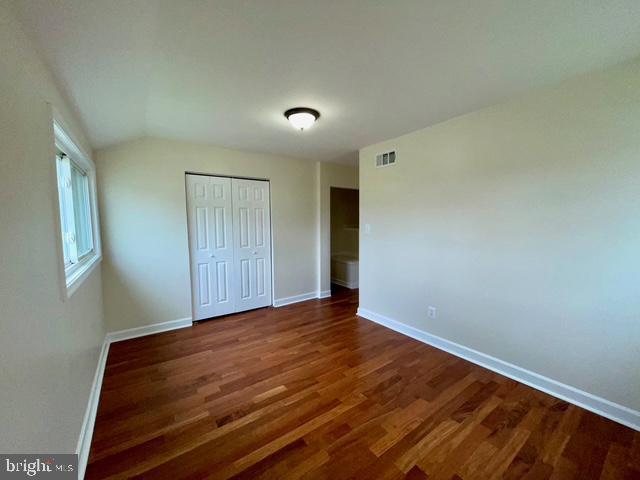 2301 Wyngate Rd, Suitland, MD 20746 - unfurnished bedroom with wood finished floors, a closet, and vaulted ceiling