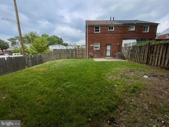2301 Wyngate Rd, Suitland, MD 20746 - rear view of property featuring a patio area, a fenced backyard, and brick siding