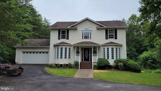 112 Pine Crest Ln, Gordonsville, VA 22942 - view of front of house featuring asphalt driveway, an attached garage, and a front yard