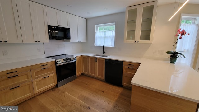 112 Pine Crest Ln, Gordonsville, VA 22942 - kitchen featuring black appliances, light wood-type flooring, glass insert cabinets, a peninsula, and light countertops