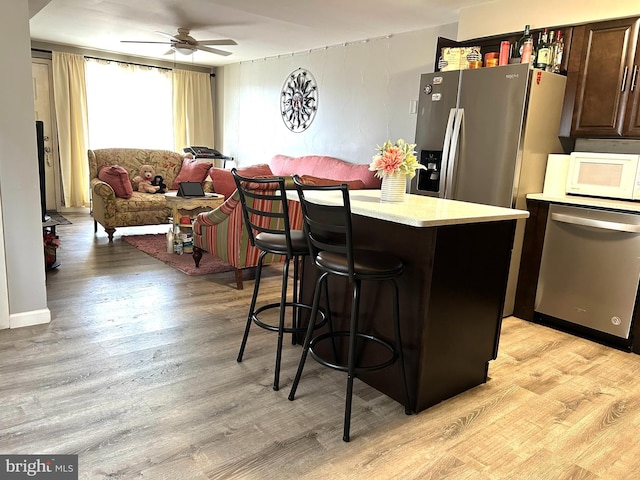 13085 Bustleton Ave Unit 612A, Philadelphia, PA 19116 - kitchen featuring stainless steel appliances, light wood-style floors, a kitchen bar, light countertops, and ceiling fan