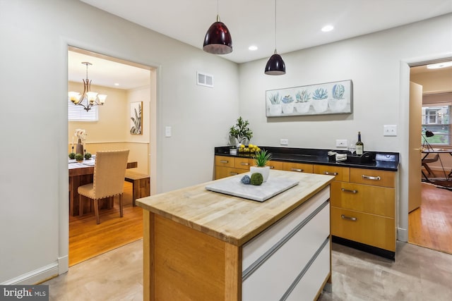 1407 Crestridge Dr, Silver Spring, MD 20910 - kitchen featuring recessed lighting, a center island, a chandelier, pendant lighting, and brown cabinetry