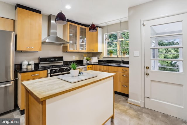 1407 Crestridge Dr, Silver Spring, MD 20910 - kitchen featuring wall chimney range hood, stainless steel appliances, a center island, glass insert cabinets, and hanging light fixtures
