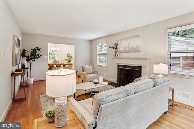 1407 Crestridge Dr, Silver Spring, MD 20910 - living area with wood finished floors, a fireplace, and a chandelier