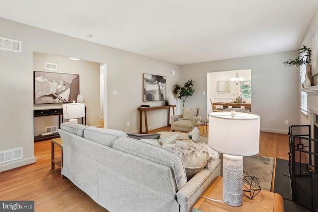 1407 Crestridge Dr, Silver Spring, MD 20910 - living room with a chandelier, wood finished floors, and a fireplace