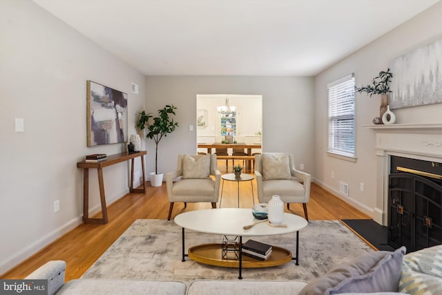 1407 Crestridge Dr, Silver Spring, MD 20910 - living room with wood finished floors, a chandelier, and a fireplace