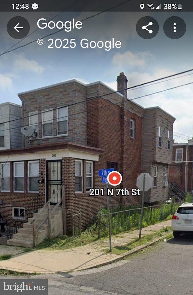 201 N 7th St, Darby, PA 19023 - view of front of house with brick siding and a chimney