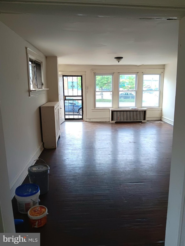201 N 7th St, Darby, PA 19023 - unfurnished living room with radiator, plenty of natural light, and dark wood finished floors