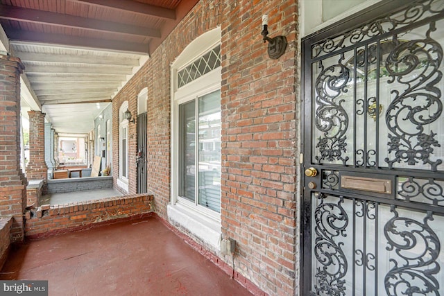 1635 Montpelier St, Baltimore, MD 21218 - view of exterior entry with a porch and brick siding