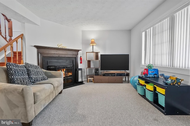 9258 Pirates Cv, Columbia, MD 21046 - living room featuring carpet flooring, a fireplace with flush hearth, stairs, and a textured ceiling