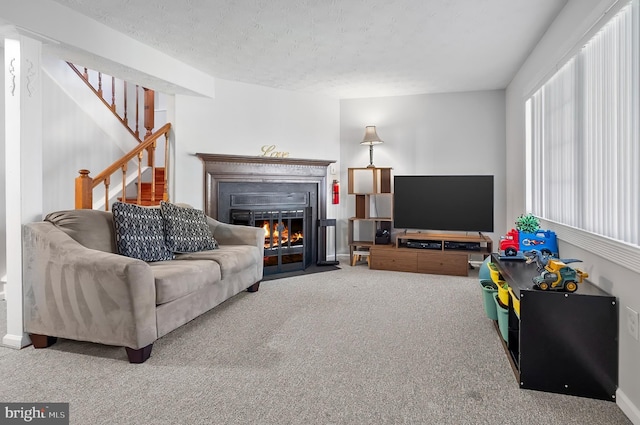 9258 Pirates Cv, Columbia, MD 21046 - living room featuring carpet floors, a fireplace with flush hearth, stairs, and a textured ceiling