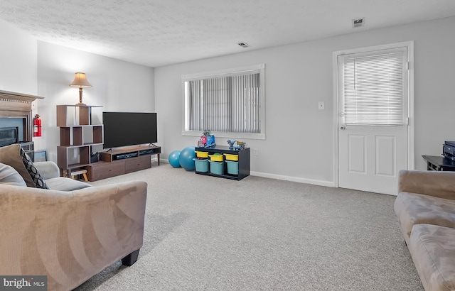 9258 Pirates Cv, Columbia, MD 21046 - living room with carpet floors, a fireplace, and a textured ceiling