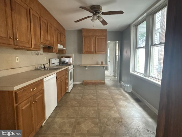 1110 E 11th St, Crum Lynne, PA 19022 - kitchen featuring white appliances, brown cabinets, and a ceiling fan