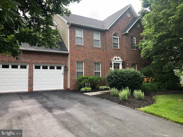 119 Artillery Rd, Winchester, VA 22602 - colonial house with brick siding, asphalt driveway, an attached garage, and roof with shingles
