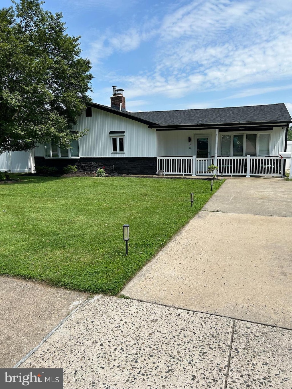 26 Thimbleberry Ln, Levittown, PA 19054 - view of front of property featuring a porch, a front lawn, a chimney, and driveway