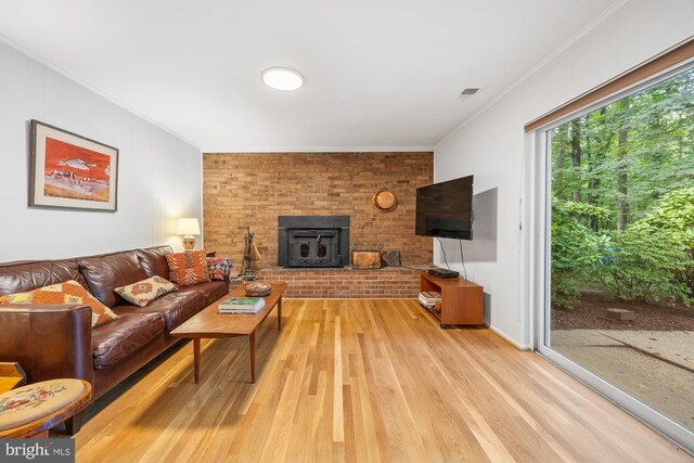 8306 Winslow Ave, Springfield, VA 22152 - living area with ornamental molding, light wood finished floors, and a fireplace