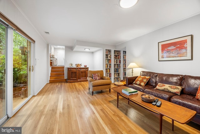 8306 Winslow Ave, Springfield, VA 22152 - living area with light wood-style flooring, crown molding, and stairway