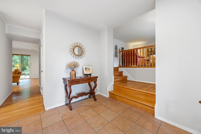 8306 Winslow Ave, Springfield, VA 22152 - foyer entrance featuring light tile patterned floors, stairs, and arched walkways