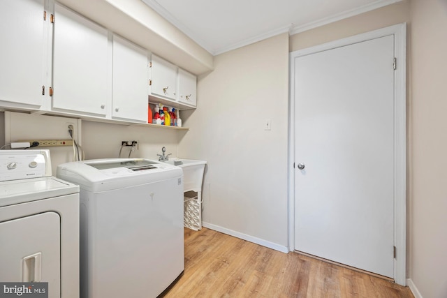 8306 Winslow Ave, Springfield, VA 22152 - washroom featuring cabinet space, washer and clothes dryer, crown molding, and light wood-style floors