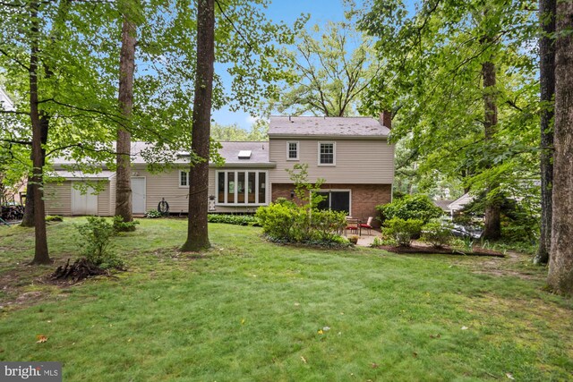 8306 Winslow Ave, Springfield, VA 22152 - back of property with a chimney, a patio, a yard, brick siding, and a storage unit