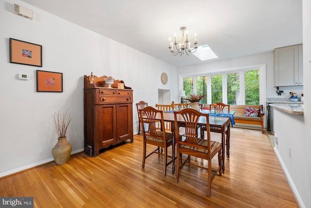 8306 Winslow Ave, Springfield, VA 22152 - dining room with light wood-style flooring and a chandelier