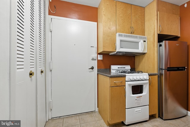 2030 F St NW Unit 111, Washington, DC 20006 - kitchen with white appliances, dark countertops, and light tile patterned floors