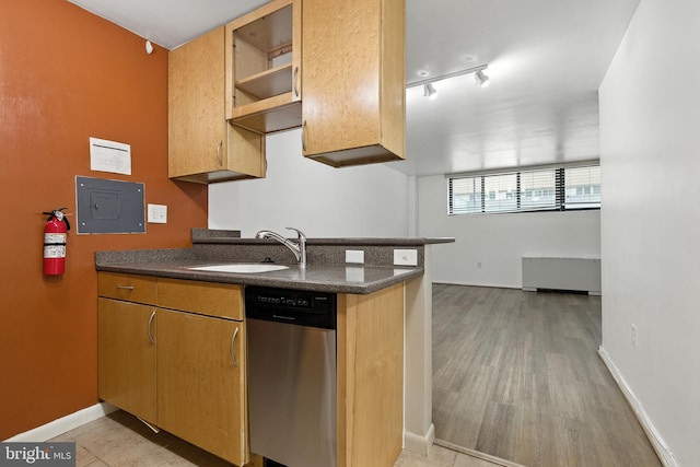 2030 F St NW Unit 111, Washington, DC 20006 - kitchen featuring stainless steel dishwasher, dark countertops, light wood-style floors, radiator, and electric panel