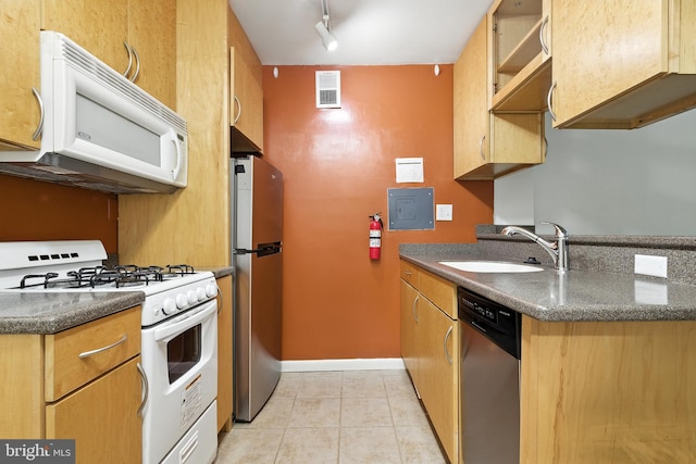 2030 F St NW Unit 111, Washington, DC 20006 - kitchen featuring appliances with stainless steel finishes, light tile patterned floors, dark countertops, and rail lighting