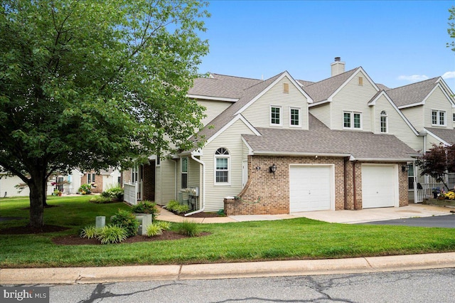 18 Standiford Ct, Wilmington, DE 19804 - view of front facade with a shingled roof, asphalt driveway, a garage, brick siding, and a front lawn